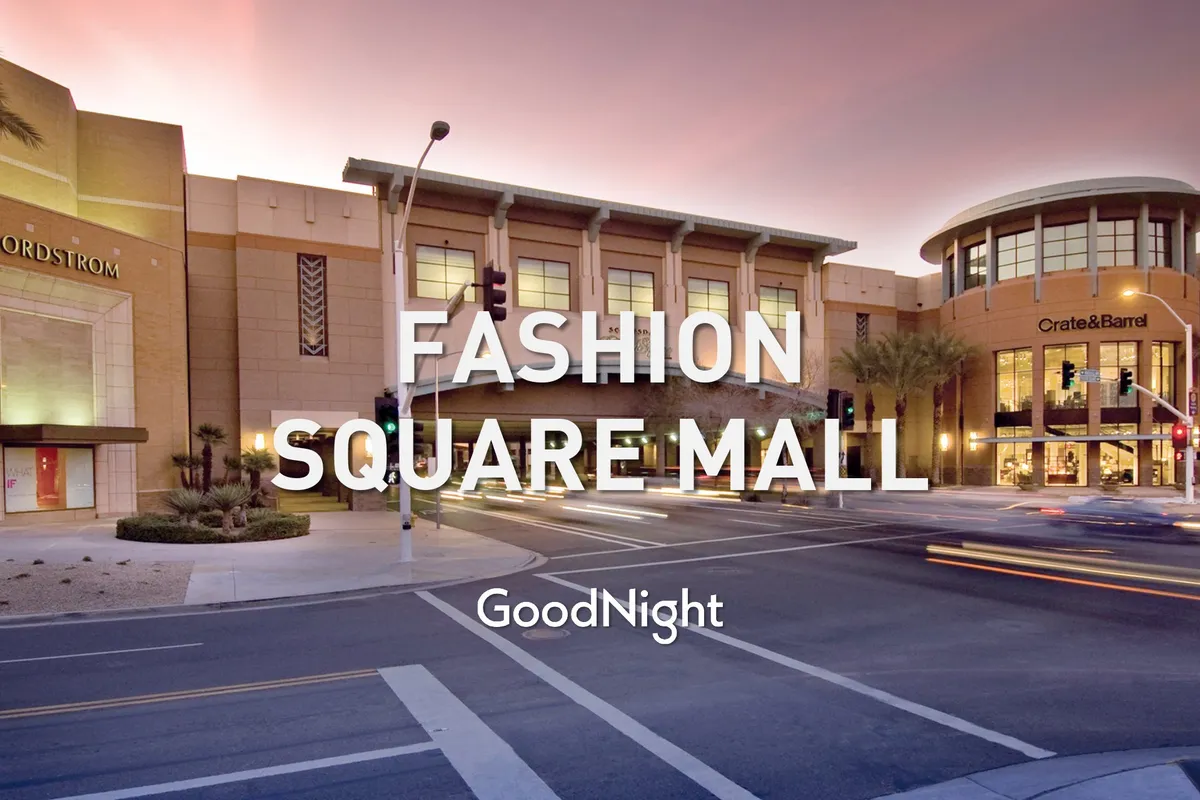 A dynamic streetscape featuring the Nordstrom entrance and Crate & Barrel store, with bustling activity, traffic lights, and the sense of a large shopping destination.
