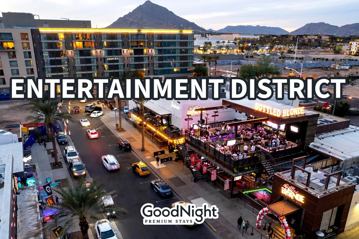 A bustling exterior scene with clear signage marking the entertainment district, busy streets lined with cars, outdoor dining areas, and a scenic mountain backdrop. The atmosphere is lively, hinting at nightlife and a variety of dining and entertainment options.